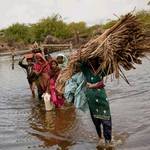 2011年9月14日，巴基斯坦巴丁一家人帶著身家財產離開被洪水包圍的村莊（攝影: Warrick Page/Getty Images for UNICEF）