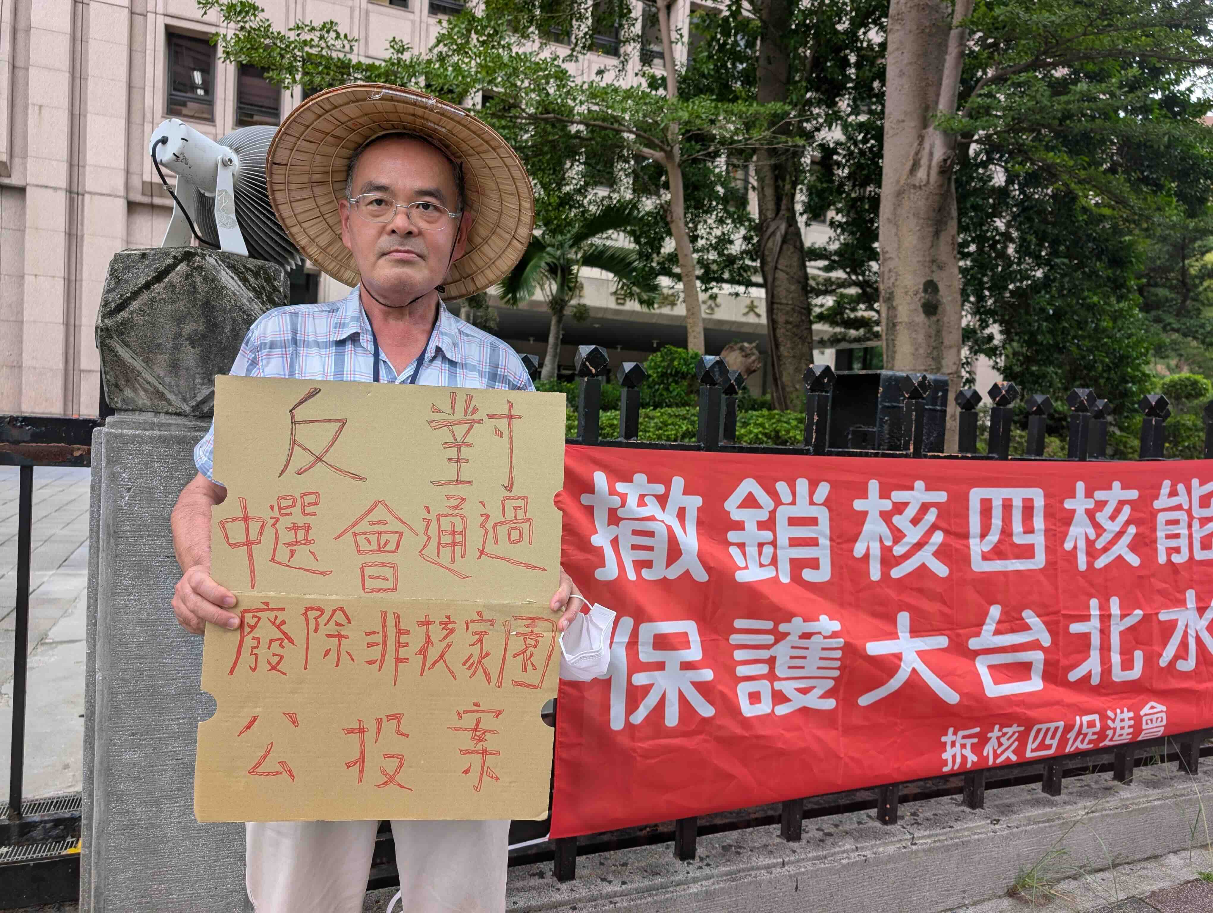 拆核四促進會總幹事楊木火今(28)日來到中選會門口,呼籲中選會不應通過「廢非核家園」公投案。攝影:陳昭宏